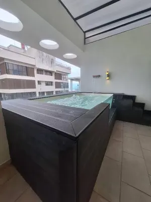 a large swimming pool in a building at Miraculus Penthouse With Private Jacuzzi in Santo Domingo