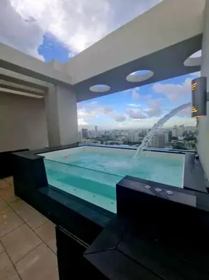a swimming pool with a view of a city at Miraculus Penthouse With Private Jacuzzi in Santo Domingo