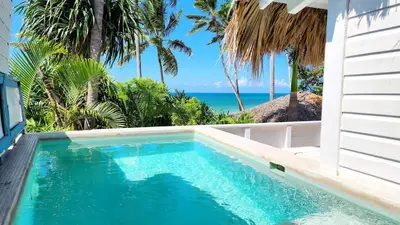 a swimming pool with a view of the ocean at BEACH FRONT 3 Bedroom Villa with Pool Sleeps 7 in Las Terrenas