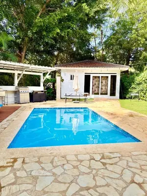 a swimming pool in front of a house at Charming 2 bed 2bath villa 77B with private pool in Sosúa