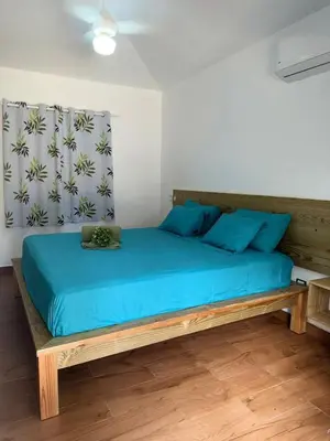 a bedroom with a bed with blue sheets and blue pillows at Charming 2 bed 2bath villa 77B with private pool in Sosúa