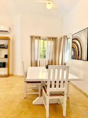 a white dining room with a white table and chairs at Charming 2 bed 2bath villa 77B with private pool in Sosúa