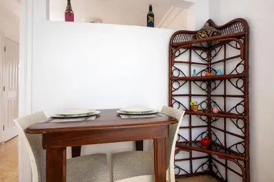 a dining room with a wooden table and chairs at Puerto Plata Home in San Felipe de Puerto Plata