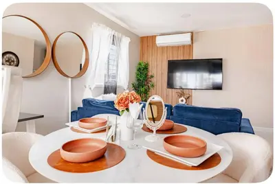 a living room with a table with plates and mirrors at Un bonito amanecer in Santo Domingo
