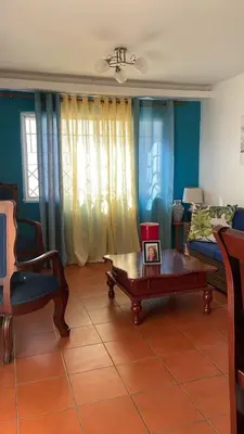 a living room with a couch and a coffee table at Residencial flor Betania in San Pedro de Macorís