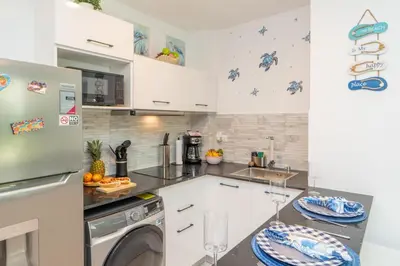a kitchen with a washer and a dishwasher at Sea Escape Casa Tortuga @ Cana Rock 1 Bdrm Bliss in Punta Cana