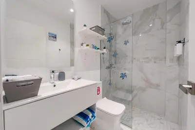 a bathroom with a shower and a toilet and a sink at Sea Escape Casa Tortuga @ Cana Rock 1 Bdrm Bliss in Punta Cana