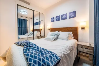 a bedroom with a large bed and a mirror at Aqua Fam Swim out Suite - Pool @ Cana Rock G 117 in Punta Cana