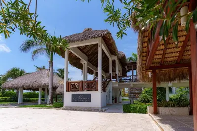 a resort with a pavilion and palm trees at Aqua Fam Swim out Suite - Pool @ Cana Rock G 117 in Punta Cana