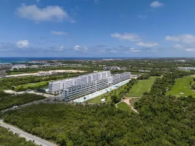 an aerial view of a large white building at Aqua Luxe @ Cana Rock terrace to pool access E-105 in Punta Cana