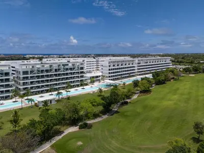 an aerial view of a resort with a golf green at Aqua Luxe @ Cana Rock terrace to pool access E-105 in Punta Cana