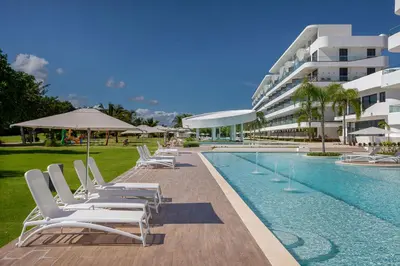a swimming pool with lounge chairs and a building at Single Loft Best Pool Views! Cana Rock Star G-205 in Punta Cana