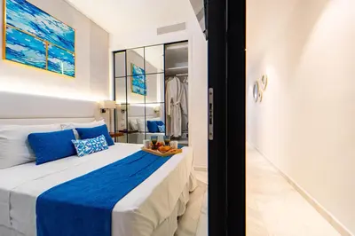 a bedroom with a large bed with blue and white sheets at Single Loft Best Pool Views! Cana Rock Star G-205 in Punta Cana