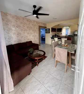 a living room with a couch and a table at Cozy 2 Bedroom Apartment Boca Chica in Boca Chica