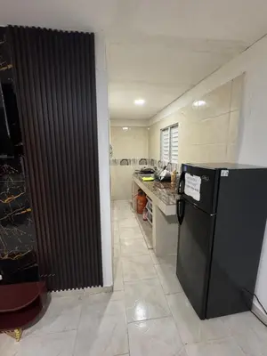 a kitchen with a black refrigerator and a counter at Apartmento Las Palmeras 1 A1 in Vicente Noble