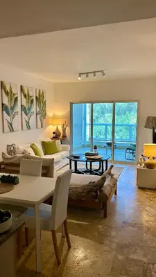 a living room with a bed and a table at Beautiful 2 bedroom apartment Playa Nueva Romana in Boca del Soco