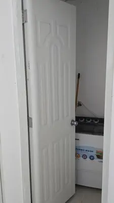 a white door in a kitchen with a stove at 4 vecinos in Santiago de los Caballeros