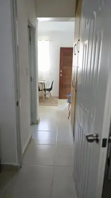 an empty hallway with a room with a table and a room at 4 vecinos in Santiago de los Caballeros