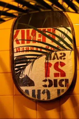 a mirror hanging on a wall with a sign at Casba Hostel in Las Terrenas