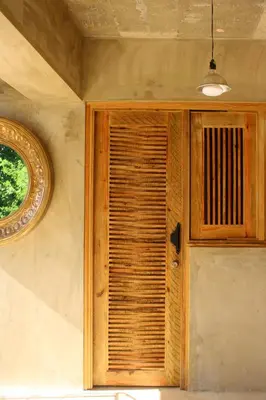a wooden cabinet in a room with a window at Casba Hostel in Las Terrenas
