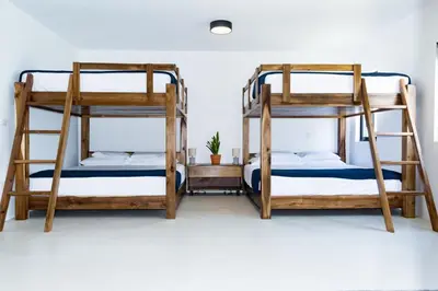 two bunk beds in a room with a white wall at Private Villa-Infinity Pool-26 guests capacity-14 King Size Beds-8 bedrooms-8 and half baths in Cabrera
