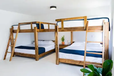two bunk beds in a room with white walls at Private Villa-Infinity Pool-26 guests capacity-14 King Size Beds-8 bedrooms-8 and half baths in Cabrera