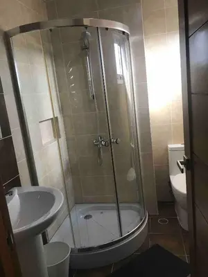 a bathroom with a shower with a sink and a toilet at Eclectic 3 levels and 5 bedrooms penthouse in Santo Domingo