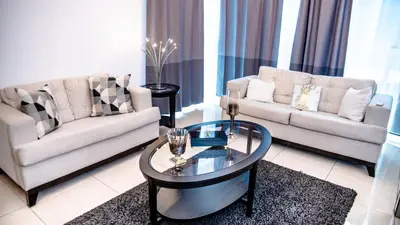 a living room with two couches and a coffee table at 3 levels and 5 bedrooms penthouse with a great view in Santo Domingo