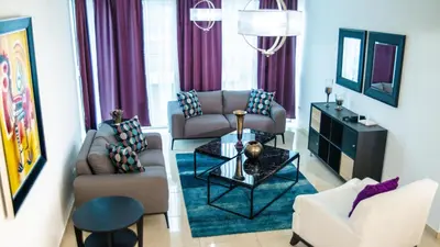 a living room with two couches and a table at 3 levels and 5 bedrooms penthouse with a great view in Santo Domingo