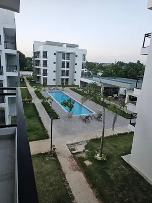 an apartment building with a swimming pool in a yard at Romana Residence Vacationing Apartment in Cumayasa Kilómetros Diez