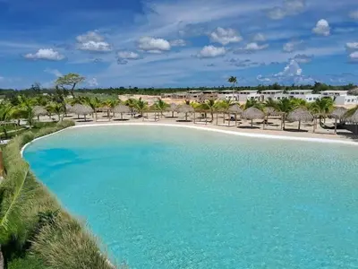 an aerial view of a pool with chairs and umbrellas at Villa Carpe Diem in Punta Cana