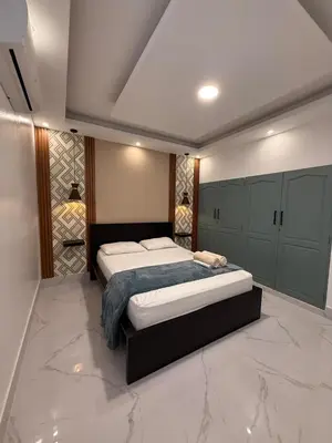 a bedroom with a large bed and a marble floor at Confortable apartamento en Villa Olga in Santiago de los Caballeros