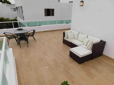 a living room with a couch and a table at Sunbreeze Villa in Oceanfront Sosua Ocean Village in Sosúa