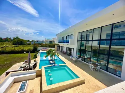 an exterior view of a house with a swimming pool at 8 BR Grand Villa in Oceanfront Comm Sosua Ocean Vill in Sosúa