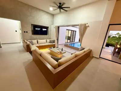 a living room with a couch and a table at Coral Villa in Oceanfront Comm Sosua Ocean Village in Sosúa