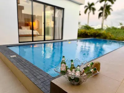 a basket of beer bottles sitting next to a swimming pool at Coral Villa in Oceanfront Comm Sosua Ocean Village in Sosúa