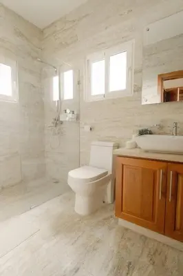 a bathroom with a toilet and a shower and a sink at Ocean View Villa in Oceanfront Sosua Ocean Village in Sosúa