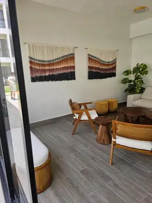 a living room with a couch and tables at Romana Residence Vacationing Apartment in Cumayasa Kilómetros Diez