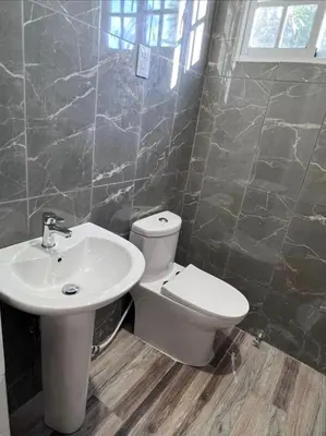 a bathroom with a toilet and a sink at Mi refugio 2 in San Fernando de Monte Cristi