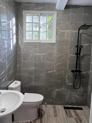 a bathroom with a toilet and a sink and a shower at Mi refugio 2 in San Fernando de Monte Cristi