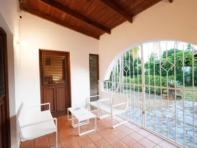 a room with a large window and white chairs at Villa silenziosa e sicura al centro di Las Galeras in Las Galeras