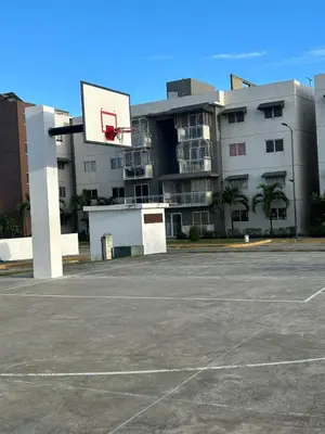 an empty parking lot with a basketball hoop in front of a building at Cozy 3br apartment near to airport & beaches in La Cana