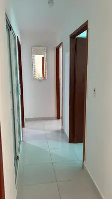 an empty hallway with doors and a tile floor at Cozy 3br apartment near to airport & beaches in La Cana