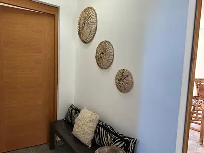 a room with three plates on a wall with a couch at Villa kiyana-14 pax, 5min de la playa en Las Galeras in Las Galeras