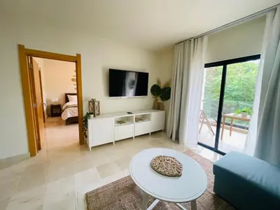 a living room with a couch and a table at Marien Residences 221 Garden & Partial Ocean View Condo in Puerto Plata
