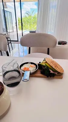 a sandwich and a bowl of food on a table at Villa YOSYMART Poolside Retreat private WIFI Luxury BBQ side in Punta Cana