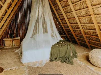 a veil hanging from the ceiling of a room at OYA New Earth Luxury Romantic Glamping with Private Outdoor Bath in Jamao al Norte