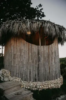a bamboo hut with a thatched roof at OYA New Earth Luxury Romantic Glamping with Private Outdoor Bath in Jamao al Norte