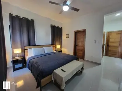 a bedroom with a bed and a ceiling fan at Villa Serene Breeze Private Pool Sosua Ocean Village in Sosúa