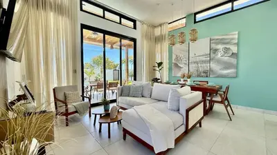 a living room with a white couch and a table at Villa Solana in Cabrera Dominican Republic in Cabrera